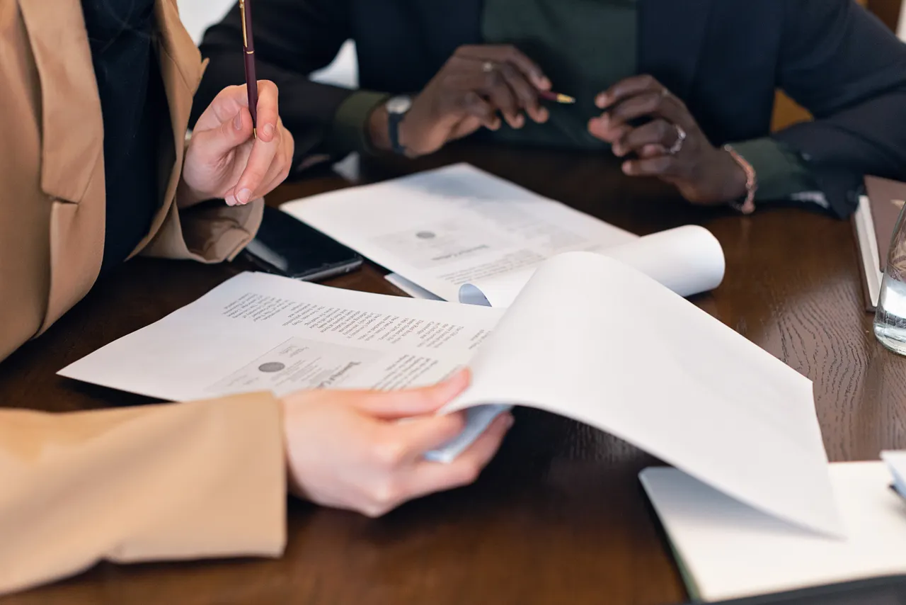 Professionals reviewing documents together at an office table