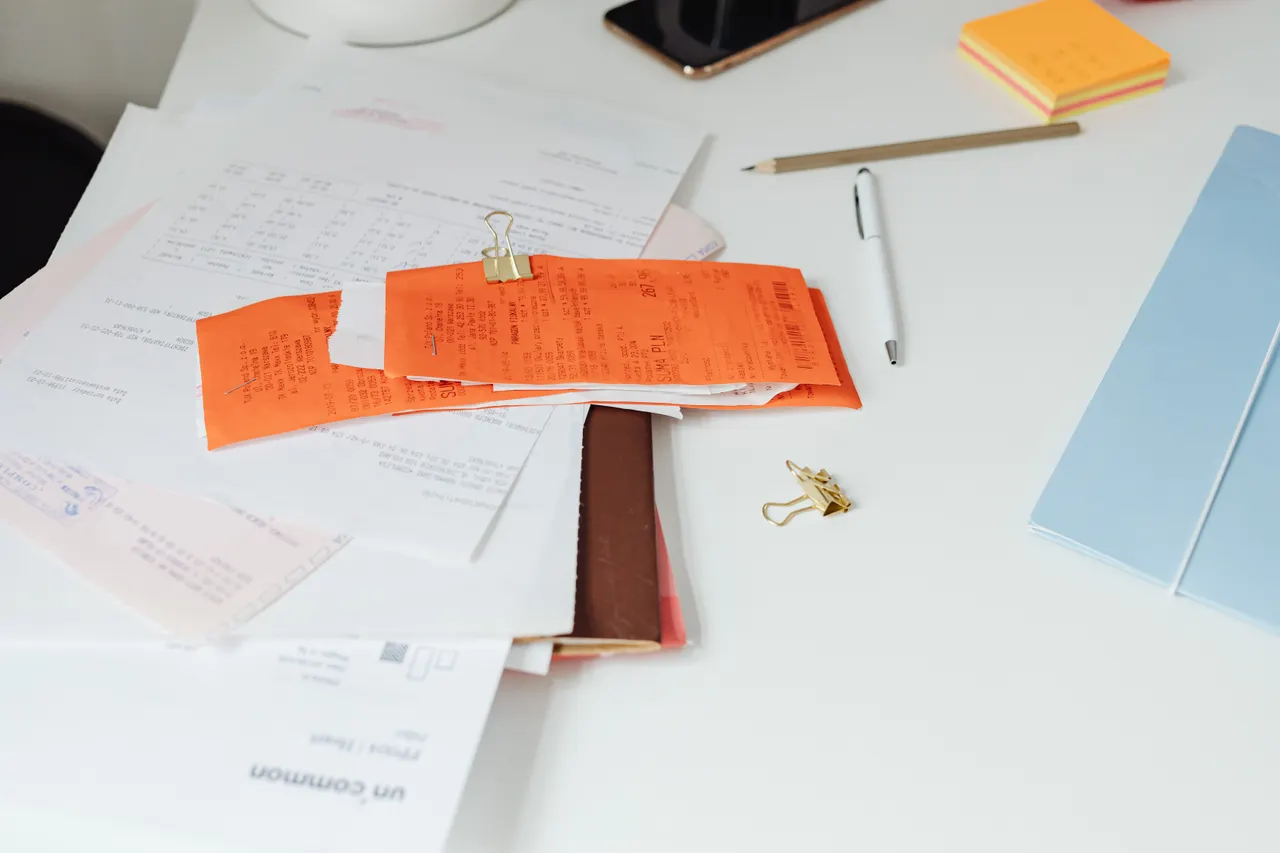 Tidy desk with receipts, documents and office stationery