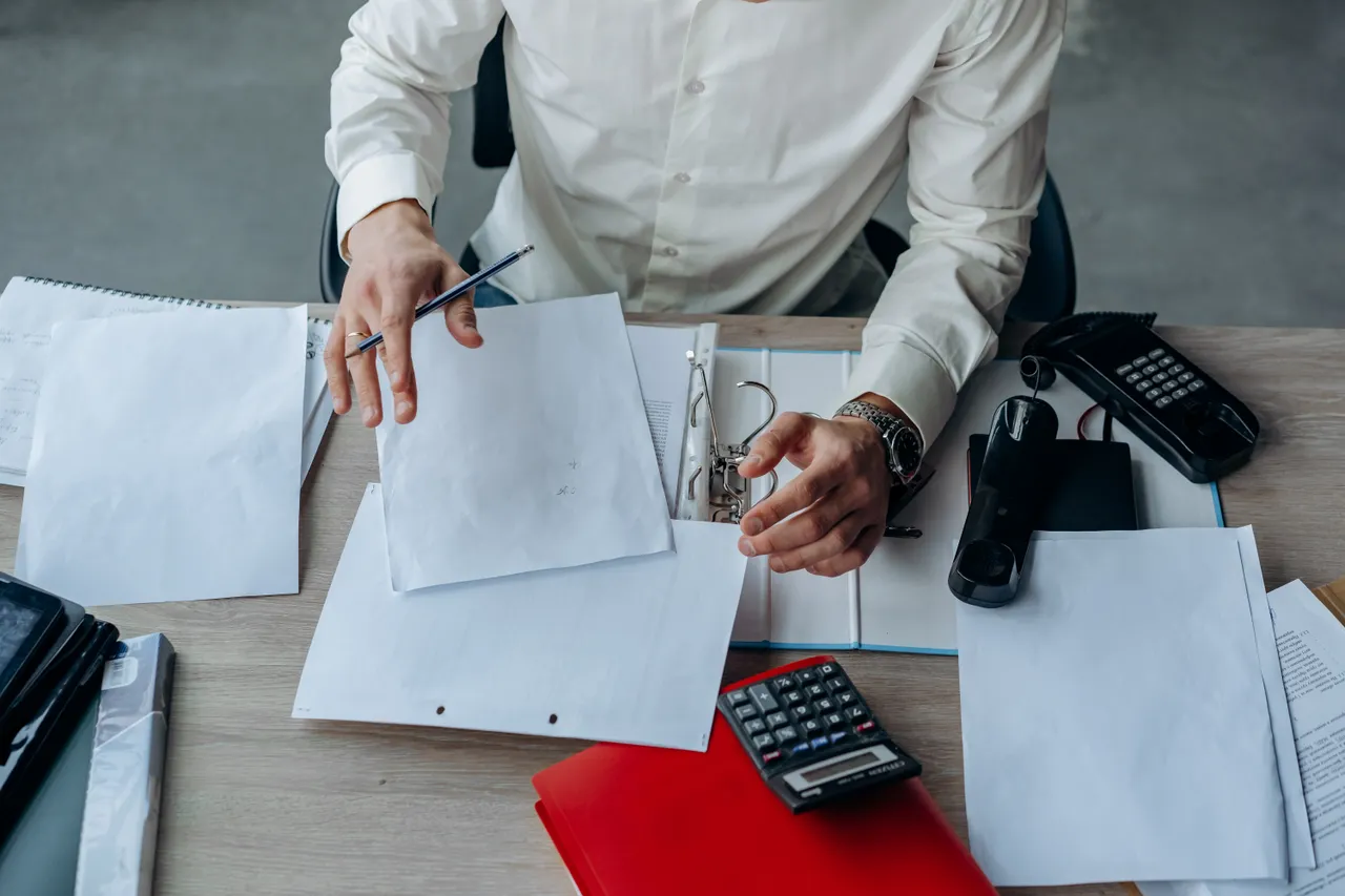 Professional organizing documents at an office desk